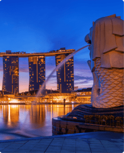 Merlion statue with Marina Bay Sands at dusk in Singapore.